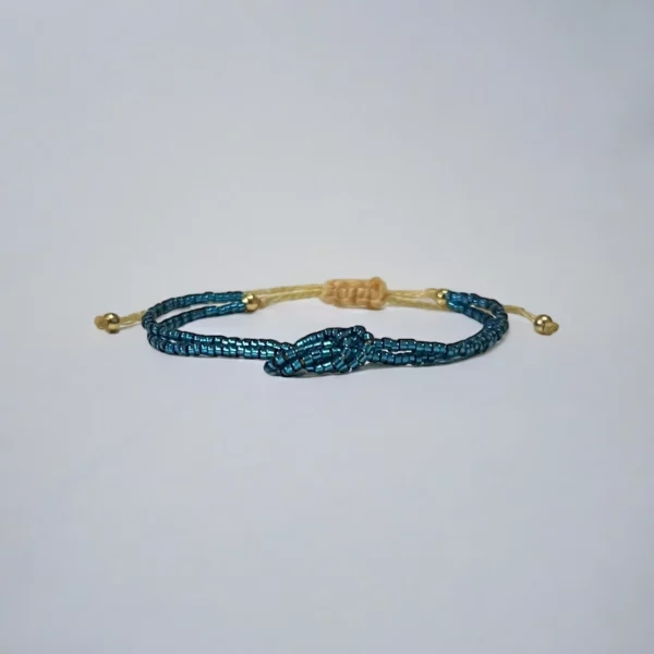Blue beaded bracelet with adjustable gold closure