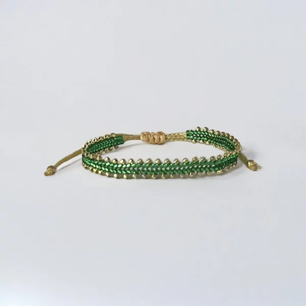 Green beaded bracelet with gold details.