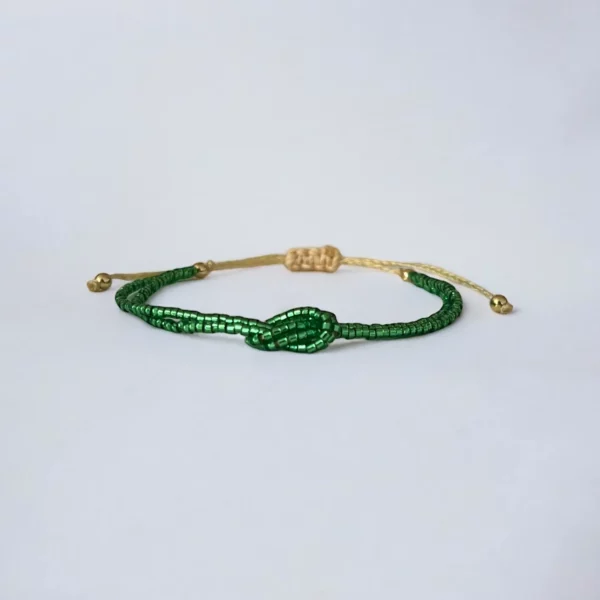 Green beaded bracelet on white background.
