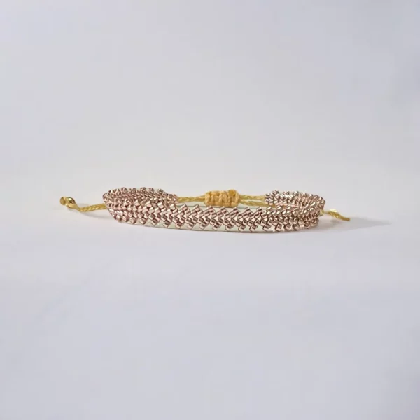 Gold chain bracelet on white background.