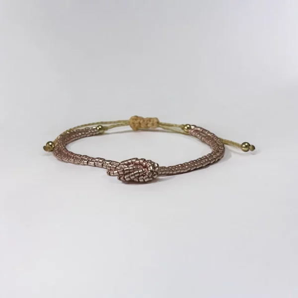 Gold snake bracelet on white background