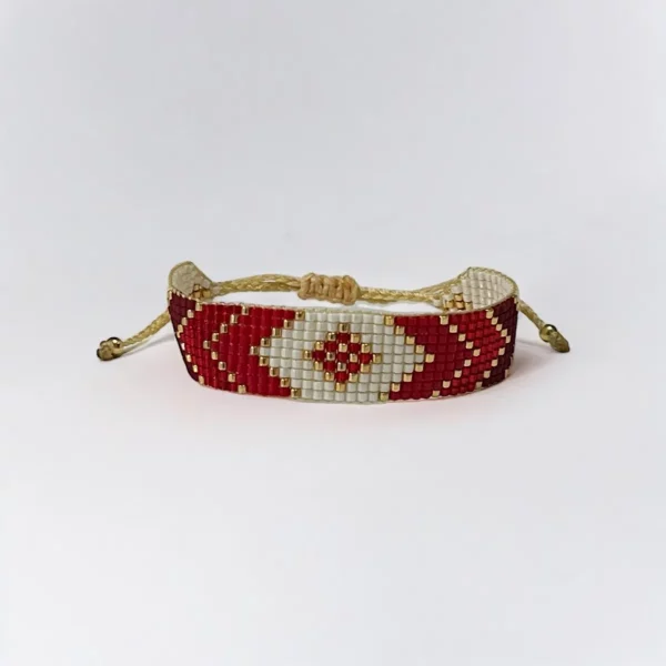 Beaded bracelet with red and white patterns.