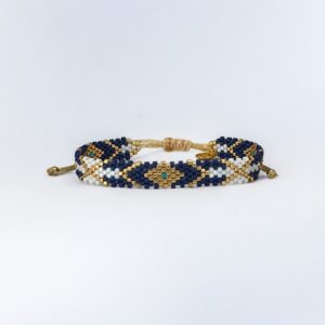 Beaded bracelet with blue and gold pattern on white background.