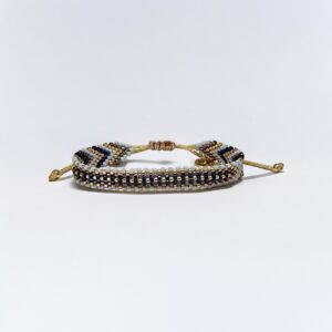 Beaded bracelet with gold accents on white background.