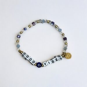 Beaded bracelet with "GOOD VIBES" message and charm.