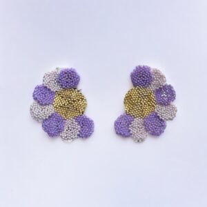 Beaded floral earrings, purple and gold, on white background.