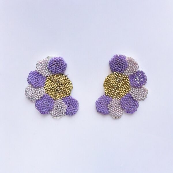 Beaded floral earrings, purple and gold, on white background.