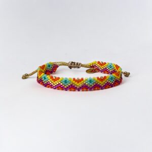Colorful beaded friendship bracelet on white background.