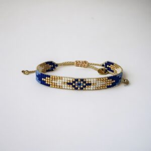 Handmade beaded bracelet with blue and gold accents.
