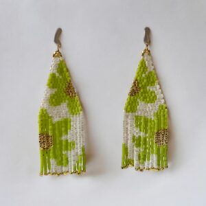 Handmade green bead fringe earrings on white background.