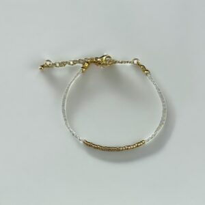 Gold and silver bracelet on white background.
