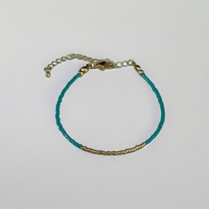Turquoise beaded bracelet with gold accents.
