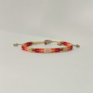 Handcrafted beaded friendship bracelet with gold accents.