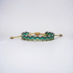 Beaded turquoise gold hairpin on white background.