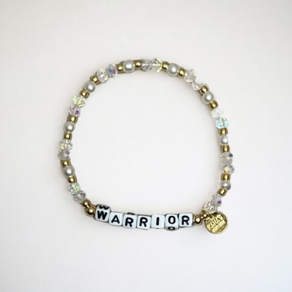 Beaded "Warrior" bracelet with charm on white background.